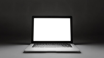 Slim modern laptop displaying a white screen in a dark room, ideal for mockups and presentations