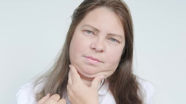 closeup face mature woman 55 years old, human fat neck, gravitational ptosis, double saggy chin, Aging and Facial Appearance, age-related skin changes, cosmetic anti-aging procedures, skin tightening