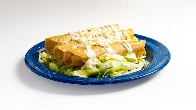 Tacos Dorados con lechuga, crema y queso