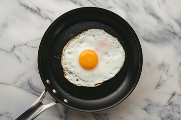 A photo of a fried egg in a black pan