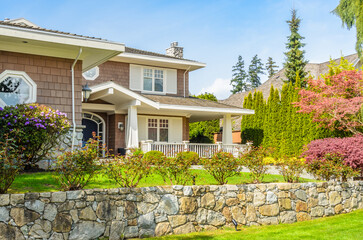 Fragment of  luxury house in summer with green trees and nice landscape in Vancouver, Canada, North America. Day time on June 2024