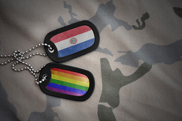army blank, dog tag with rainbow gay pride flag and paraguay on the khaki texture background. military concept.