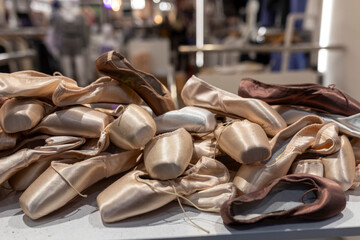 Ballet pointe shoes displayed on a stand at a vintage flea market for sale.