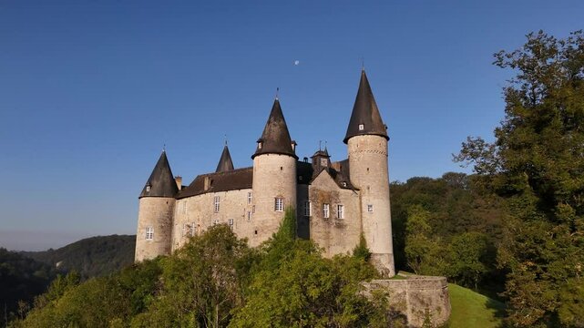 Explore the enchanting Veves Castle surrounded by lush greenery and blue skies