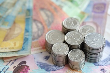 Few stacks of ukrainian money coins lies on old hryvnia banknotes