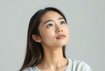 Half-length portrait of a 25-year-old Asian female with a gentle, calm expression