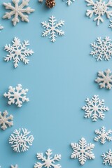 A festive arrangement of white snowflakes on a soft blue background, perfect for winter-themed decorations or seasonal celebrations.