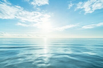 Obraz premium Vast calm ocean under bright sky with soft clouds at midday