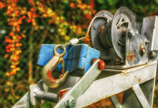 Close-up of a winch with a large, metal hook.
Capstan winch for transporting boats.