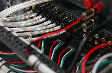 Obraz premium Connection of electronic modules in a multimedia telecommunication rack. Soft focus. 