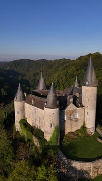 Explore the enchanting Veves Castle surrounded by lush forests and hills