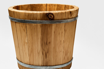 Wooden bucket with black bands on it. Wooden bucket with a white background. A white bucket with a light on it stands on a wooden background. Wooden bucket with white lifestyle light on the.