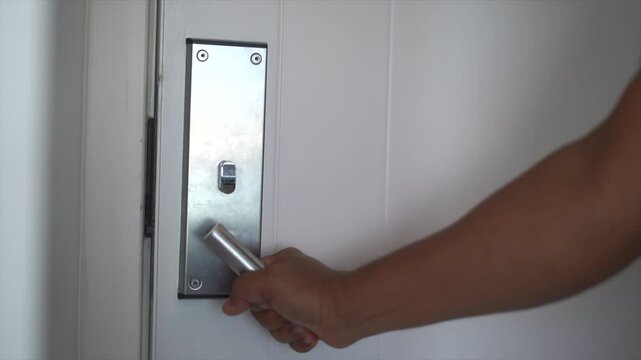 Open the room door with your hand and key card.