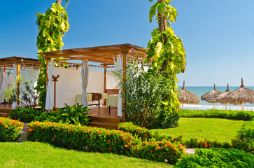 Gorgeous spa relaxation gazebo over beautiful garden and ocean view