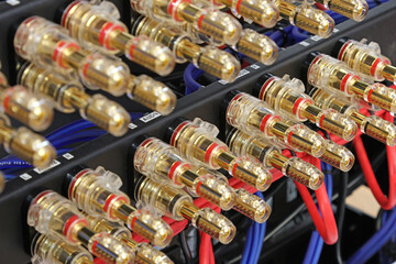 Fototapeta premium Acoustic terminals for connecting speaker systems to audio amplifiers in a telecommunications rack.