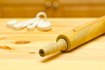 Rolling Pin and Measure cups on Wooden Board.