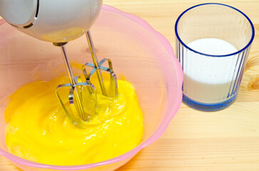 Beaten Eggs with Mixer Whisks in Bowl