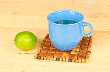Cup tea with lemon on the pad.