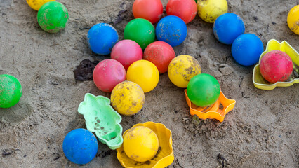 Colorful children's toys in a sandbox