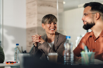 Businesswoman smiling during corporate meeting with colleagues