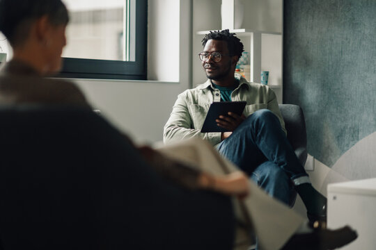 Businessman using digital tablet during meeting in modern office