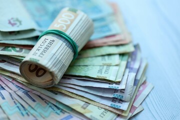 Big amount of different ukrainian hryvnia currency money bills on wooden background