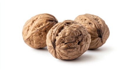 closeup shot of three whole walnuts on a clean white background perfect for food photography or health and nutrition concepts