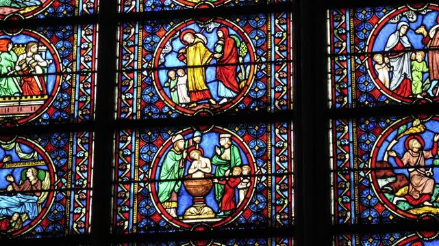 Stunning stained glass windows displaying biblical narratives at Notre Dame Cathedral in Paris, &Icirc;le-de-France, France