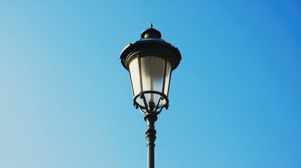 Modern architectural streetlight against a clear blue sky showcasing elegant design and vintage charm in urban settings.
