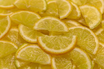 Slices of vibrant lemons arranged beautifully on a bright surface in a sunny kitchen setting