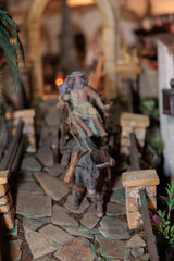 Donkey pulling cart with man in nativity scene miniature
