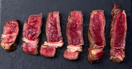 Ribeye grilled  beef steak sliced . Rare doneness photography . Macro shot . Top view