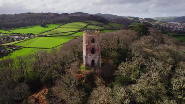 Aerial shot of Conygar Tower and woodland near Dunster village in Somerset, UK