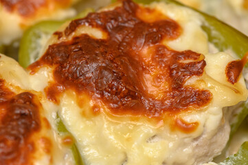 Cheese-topped stuffed bell peppers baked to golden perfection during a cozy evening gathering