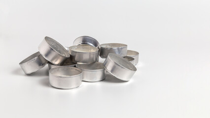 Used aluminum tea light cups isolated on white background with copy space
