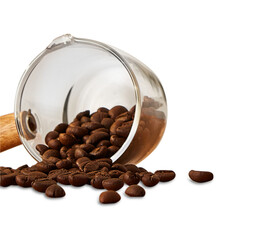 A close-up view of roasted coffee beans spilling out of a transparent glass cup with a wooden...