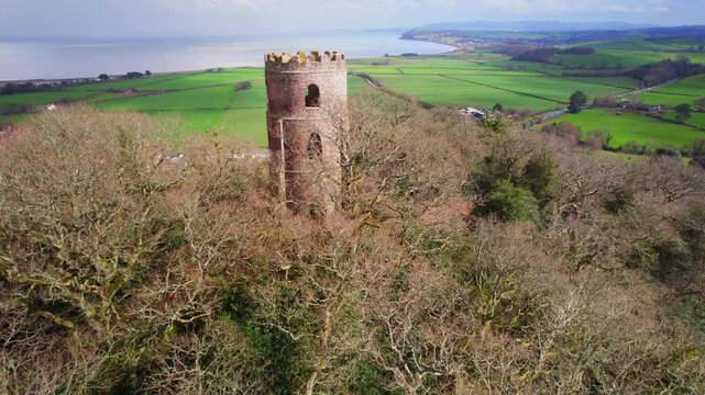 Aerial shot of Conygar Tower with Somerset coastline in background.