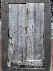 Window boarded up in an abandoned house.
