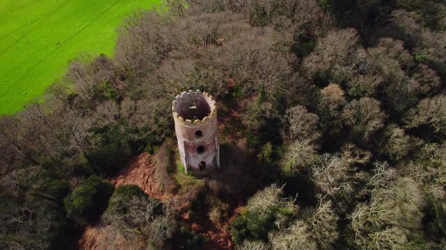 Aerial shot of Conygar Tower and woodland near Dunster village in Somerset, UK