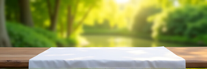 Tablecloth is neatly arranged on a wooden table against a blurred green garden backdrop in the morning light._00003_