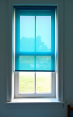 Fototapeta premium Shut window with a bright blue shutter to allow filtered natural light into the room slowly._00003_