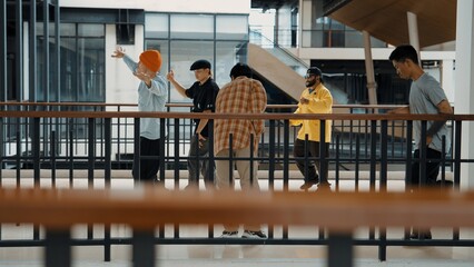 Multicultural hipster group walking while dancing at modern corridor. Attractive break dance team happy and joy while moving to hip-hop music. Active. Site view. Outdoor sport 2024. Hiphop.