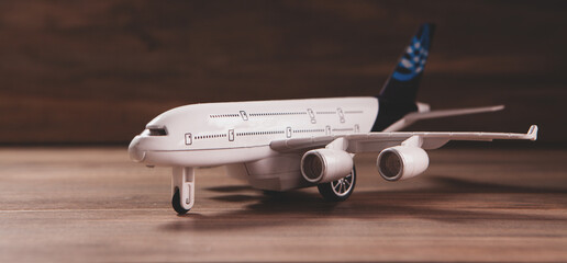 toy airplane with toy plane on a wooden table.