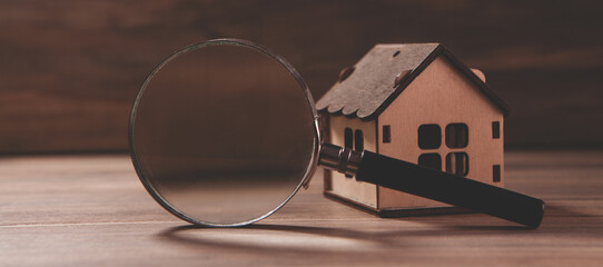 house model and magnifying glass on a table