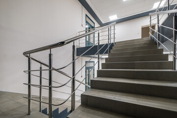 stairs emergency and evacuation exit stair in up ladder in a new office building at night