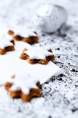 Christmas cookies (cinnamon stars) on bright background. Close up.