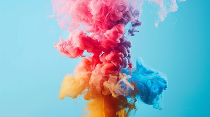 Abstract colorful ink clouds blending in water on blue background