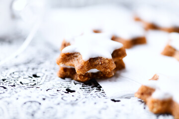 Christmas cookies (cinnamon stars) on bright background. Close up.