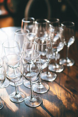 cozy village scene of a Dry January celebration, with empty wine glasses surrounded by pine branches and candles. A celebration without alcohol, with a peaceful, wintery atmosphere.
