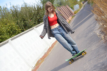 Caucasian teenage girl in casual clothes holding skateboard have fun spend time weekend summer holidays in skate park after lessons